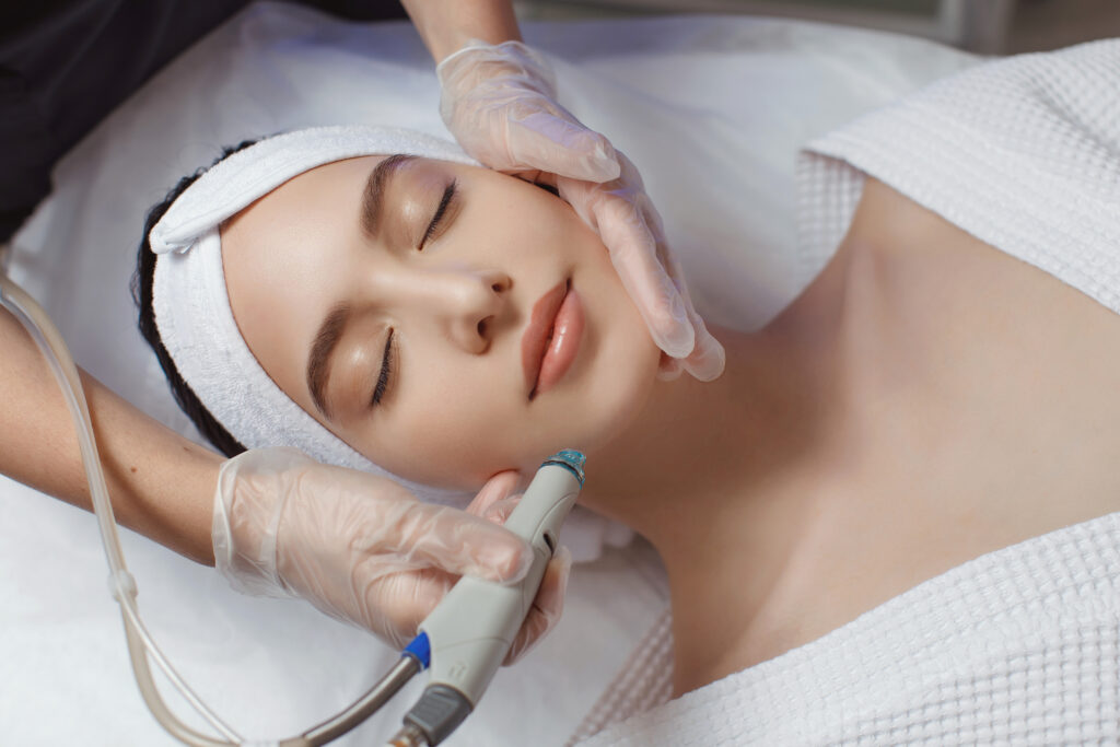 woman receiving microdermabrasion therapy forehead beauty spa